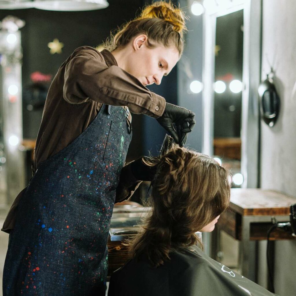 A Hairdresser cutting a Women's hair in a Hair salon in the Sutherland Shire